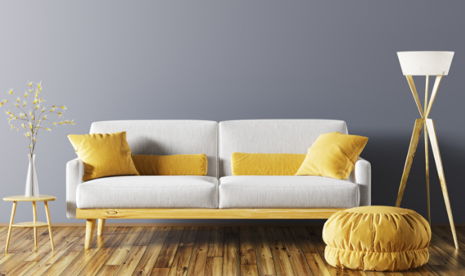 Cream sofa with yellow footstool