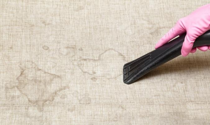 Discoloured Grey Couch Being Cleaned