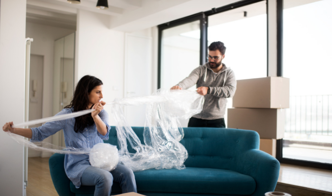 Protecting sofa with bubble wrap for moving