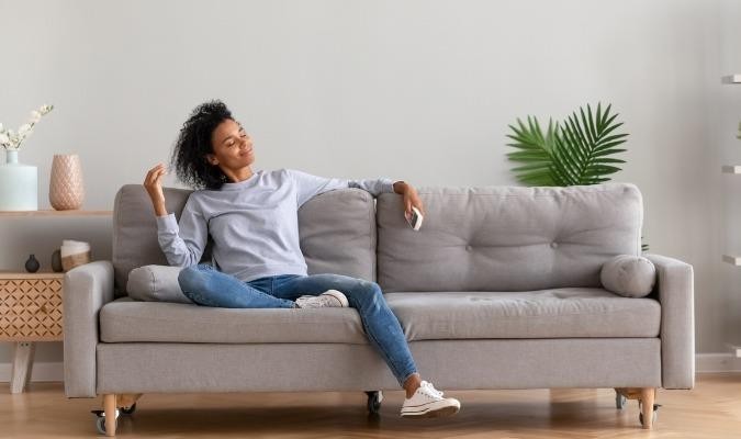 Woman Sat On Reupholstered Sofa