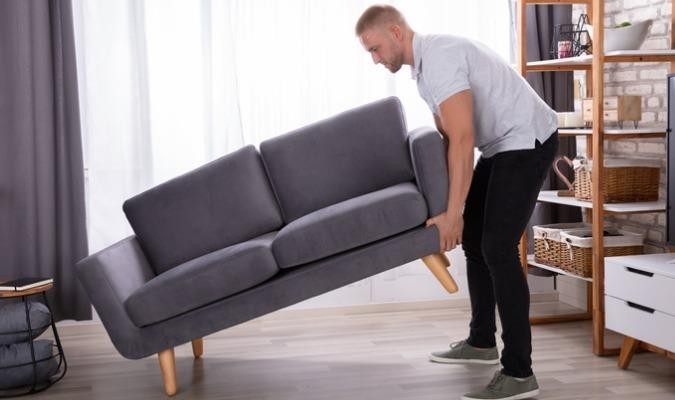 Man checking the quality of his sofa frame